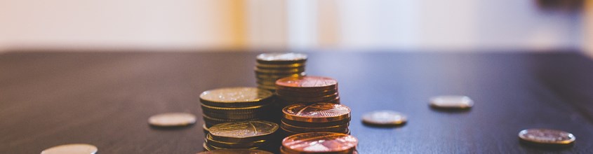 Pile Of Brown Coins On Brown Wooden Table Top 144233